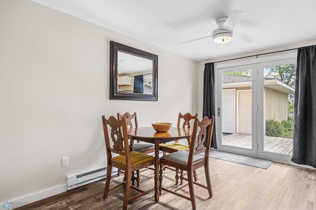 1138 20th St N, Moorhead, MN 56560 - dining area featuring a baseboard heating unit, wood finished floors, ceiling fan, and baseboards