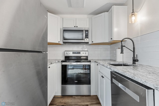 1138 20th St N, Moorhead, MN 56560 - kitchen featuring appliances with stainless steel finishes, a sink, light stone countertops, white cabinetry, and backsplash