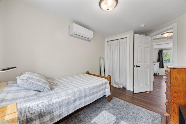 1138 20th St N, Moorhead, MN 56560 - bedroom with a wall mounted AC, dark wood-type flooring, a closet, and baseboards