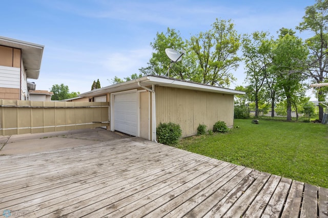 1138 20th St N, Moorhead, MN 56560 - wooden terrace featuring driveway, an outbuilding, and a garage