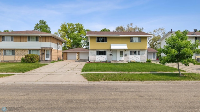 1138 20th St N, Moorhead, MN 56560 - view of front of home with an outbuilding, a detached garage, and a front yard