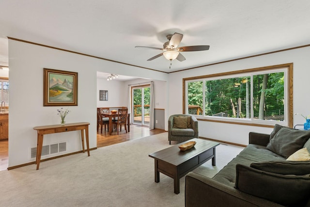 3228 Spruce Trl SW, Prior Lake, MN 55372 - living room with ceiling fan, light colored carpet, and ornamental molding