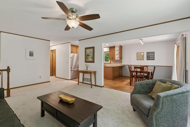 3228 Spruce Trl SW, Prior Lake, MN 55372 - living room with light carpet, a ceiling fan, and crown molding
