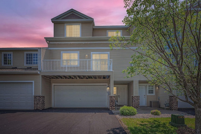 7754 Lachman Ave NE, Otsego, MN 55301 - view of front of home with brick siding, a balcony, central AC, and driveway