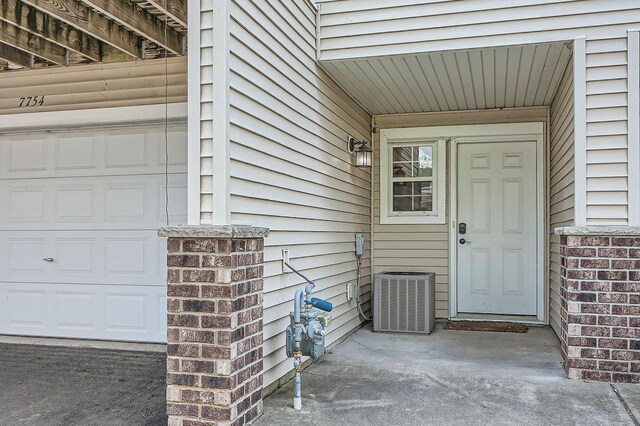 7754 Lachman Ave NE, Otsego, MN 55301 - property entrance featuring central air condition unit and a garage