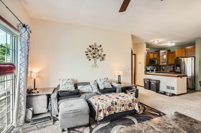 7754 Lachman Ave NE, Otsego, MN 55301 - living area with light carpet, a textured ceiling, and ceiling fan