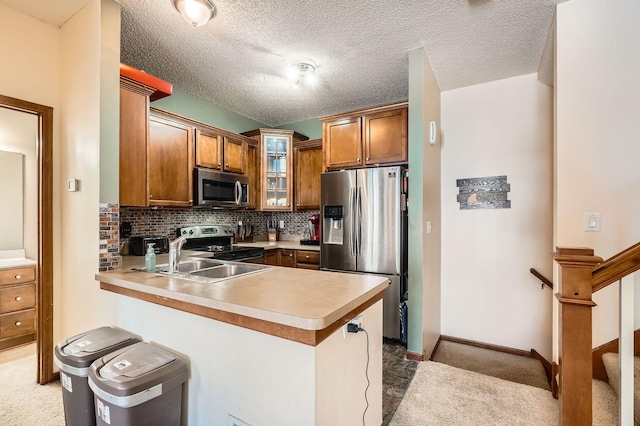 7754 Lachman Ave NE, Otsego, MN 55301 - kitchen featuring stainless steel appliances, a peninsula, brown cabinets, and glass insert cabinets