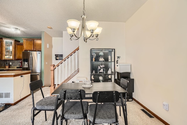 7754 Lachman Ave NE, Otsego, MN 55301 - dining room with a chandelier, light carpet, stairs, a textured ceiling, and baseboards
