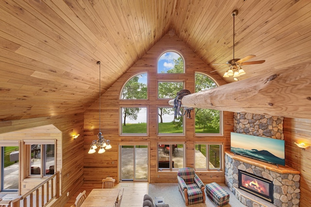 6031 232nd St W, Faribault, MN 55021 - living area featuring high vaulted ceiling, wooden ceiling, wooden walls, a fireplace, and a chandelier