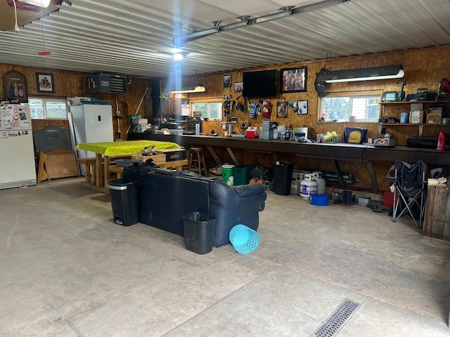 20906 624th Ave, Litchfield, MN 55355 - garage featuring a workshop area and wood walls