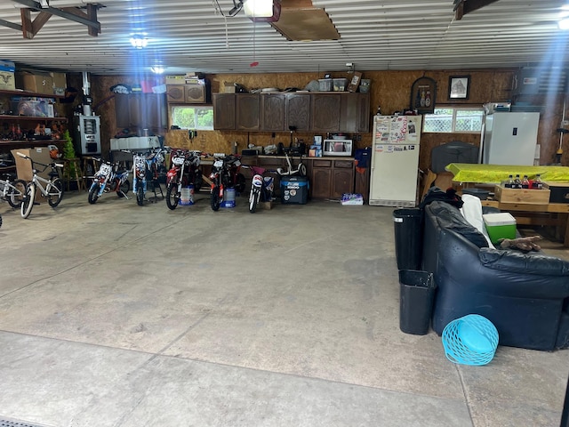 20906 624th Ave, Litchfield, MN 55355 - garage featuring freestanding refrigerator and a garage door opener