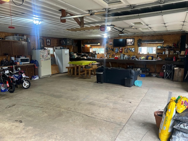 20906 624th Ave, Litchfield, MN 55355 - garage with a workshop area and freestanding refrigerator