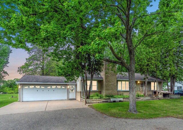 6379 Hodgson Rd, Lino Lakes, MN 55014 - view of front of house featuring concrete driveway, a front lawn, and a shingled roof