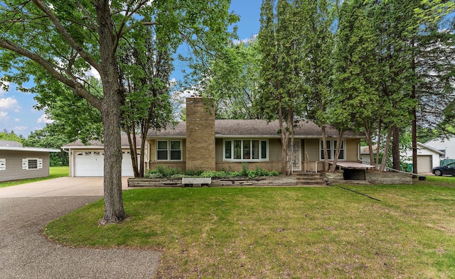 6379 Hodgson Rd, Lino Lakes, MN 55014 - ranch-style house featuring driveway, a chimney, a front lawn, an attached garage, and brick siding