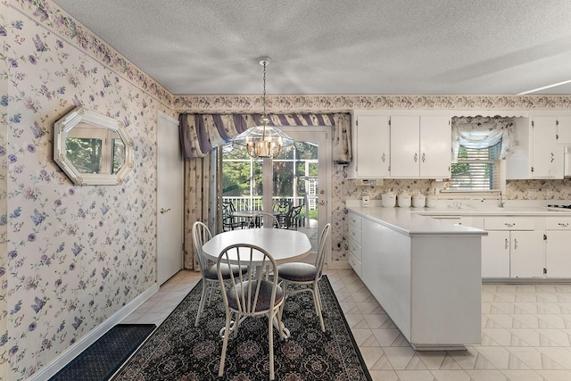 6379 Hodgson Rd, Lino Lakes, MN 55014 - dining room featuring wallpapered walls, a chandelier, a textured ceiling, and light tile patterned floors