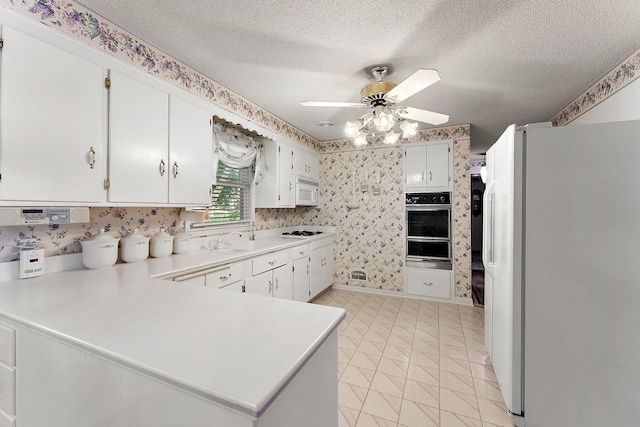 6379 Hodgson Rd, Lino Lakes, MN 55014 - kitchen with white appliances, ceiling fan, a warming drawer, a peninsula, and light countertops