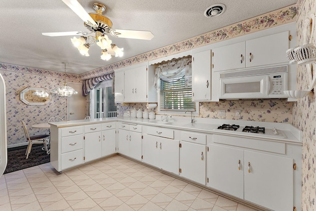 6379 Hodgson Rd, Lino Lakes, MN 55014 - kitchen featuring white appliances, wallpapered walls, light countertops, white cabinetry, and ceiling fan
