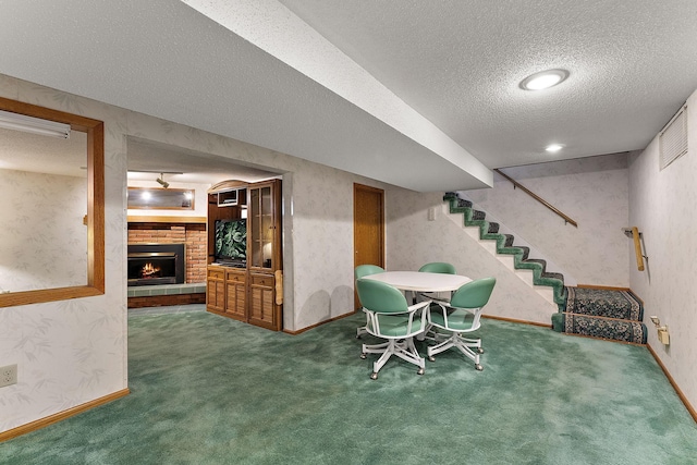 6379 Hodgson Rd, Lino Lakes, MN 55014 - dining room featuring a textured ceiling, carpet, a fireplace, stairway, and wallpapered walls