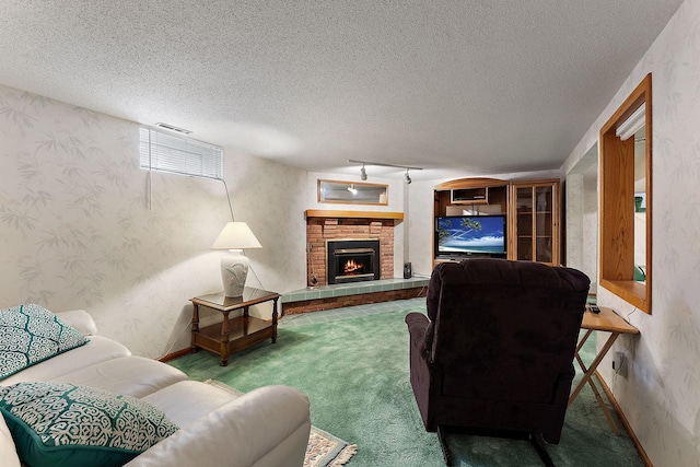 6379 Hodgson Rd, Lino Lakes, MN 55014 - living room featuring wallpapered walls, carpet flooring, a textured ceiling, and a lit fireplace