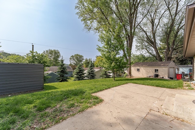 3568 6th St NW, Rochester, MN 55901 - view of grassy yard with an outbuilding and a patio