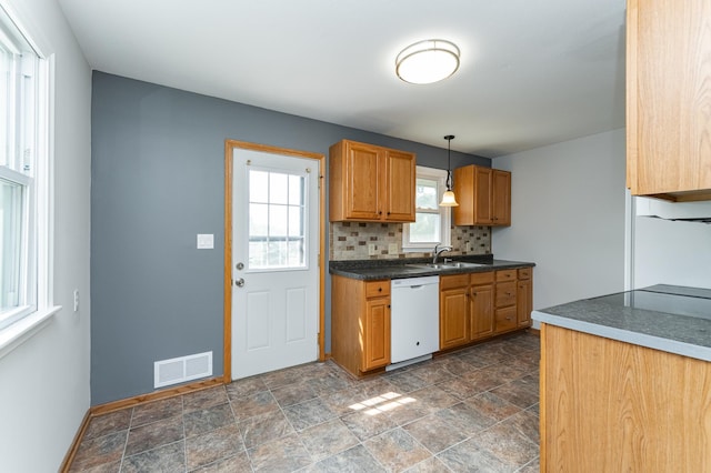 3568 6th St NW, Rochester, MN 55901 - kitchen featuring dishwasher, a sink, stone finish floors, backsplash, and baseboards