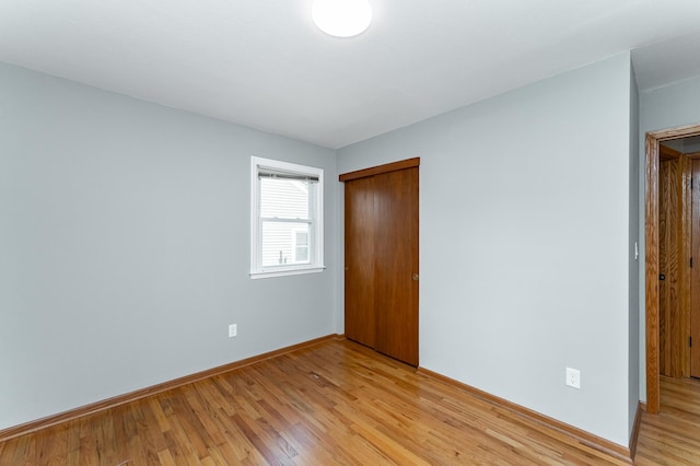 3568 6th St NW, Rochester, MN 55901 - unfurnished bedroom with light wood finished floors, a closet, and baseboards