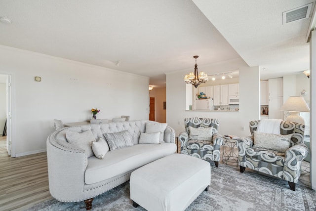 6600 Lyndale Ave S Unit 1005, Richfield, MN 55423 - living area featuring light wood-style floors, a chandelier, baseboards, and rail lighting