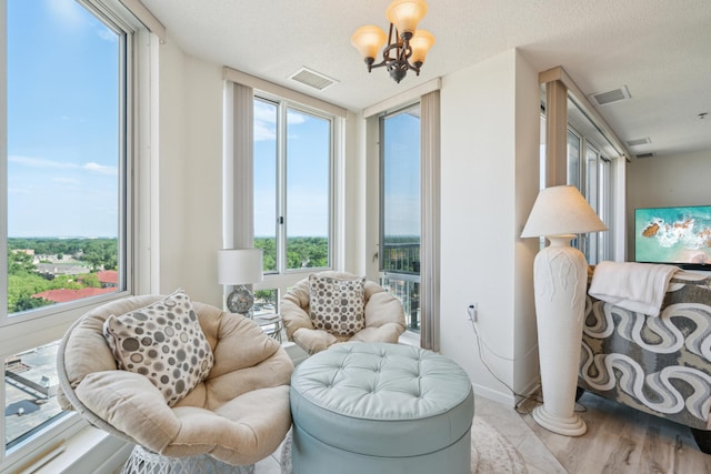 6600 Lyndale Ave S Unit 1005, Richfield, MN 55423 - living area with a chandelier, healthy amount of natural light, wood finished floors, and baseboards