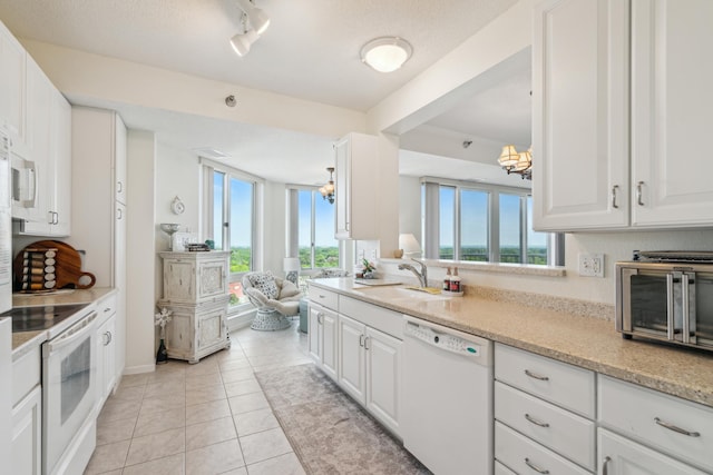 6600 Lyndale Ave S Unit 1005, Richfield, MN 55423 - kitchen featuring white appliances, a sink, white cabinets, and light tile patterned floors