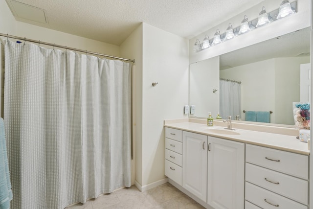 6600 Lyndale Ave S Unit 1005, Richfield, MN 55423 - bathroom with tile patterned floors, vanity, a textured ceiling, and a shower with curtain