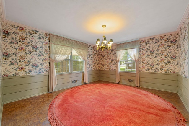 1170 Truman Ave, Owatonna, MN 55060 - empty room featuring ornamental molding, a chandelier, wallpapered walls, healthy amount of natural light, and wainscoting