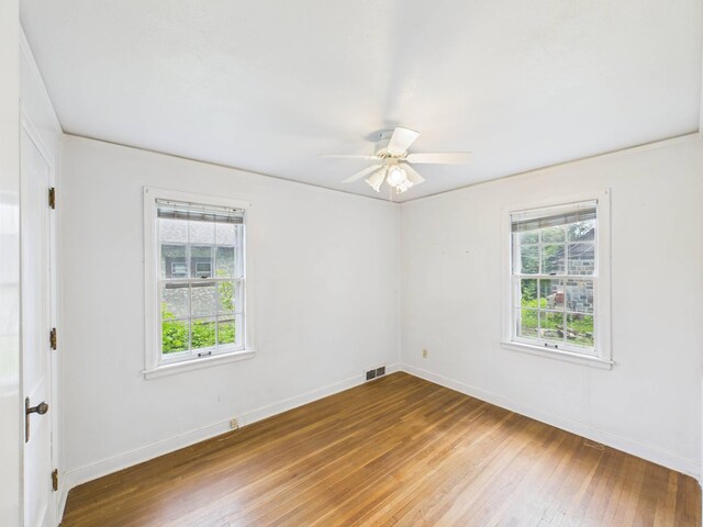 1538 8th Ave SE, Saint Cloud, MN 56304 - empty room featuring hardwood / wood-style floors, a ceiling fan, and baseboards