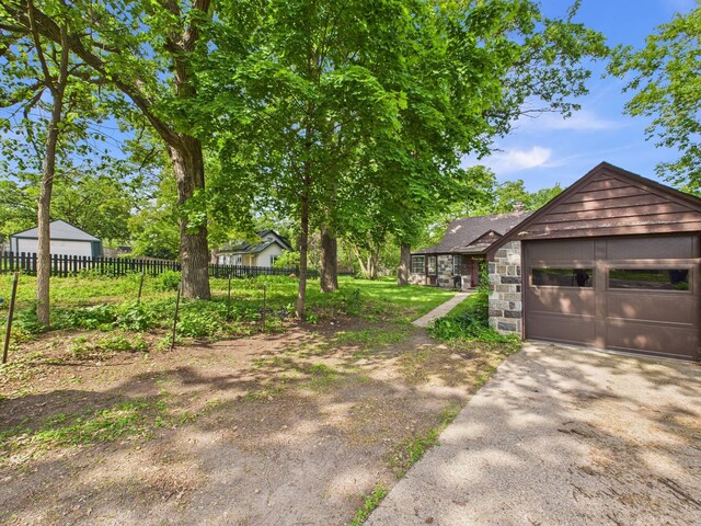 1538 8th Ave SE, Saint Cloud, MN 56304 - view of yard with asphalt driveway and a garage