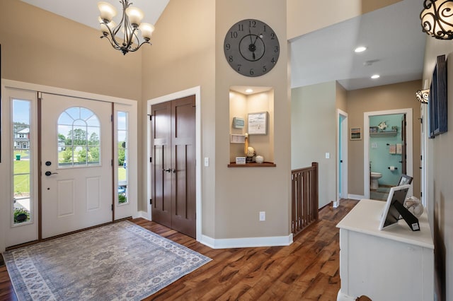 25455 145th St NW, Zimmerman, MN 55398 - entrance foyer featuring wood finished floors, baseboards, a high ceiling, and a chandelier