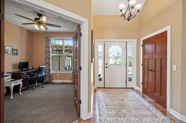 25455 145th St NW, Zimmerman, MN 55398 - foyer featuring a chandelier, baseboards, a ceiling fan, wood finished floors, and a towering ceiling
