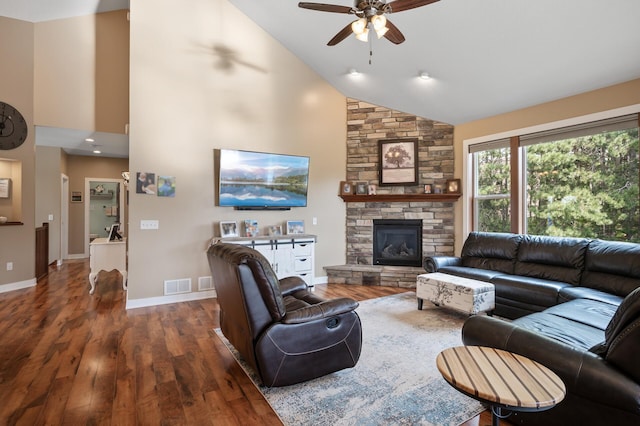 25455 145th St NW, Zimmerman, MN 55398 - living area featuring ceiling fan, high vaulted ceiling, dark wood-style floors, a stone fireplace, and baseboards