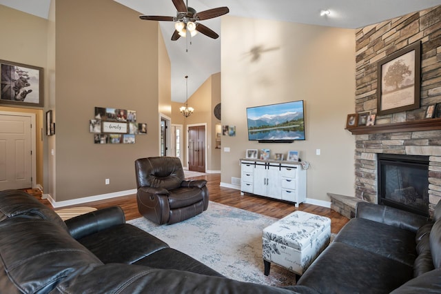 25455 145th St NW, Zimmerman, MN 55398 - living room featuring high vaulted ceiling, ceiling fan, baseboards, wood finished floors, and a chandelier