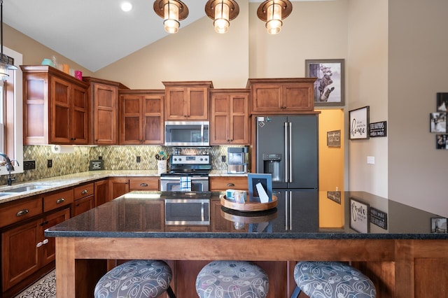 25455 145th St NW, Zimmerman, MN 55398 - kitchen featuring stainless steel appliances, a sink, backsplash, a kitchen breakfast bar, and high vaulted ceiling