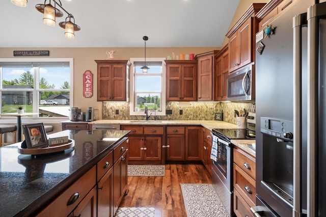 25455 145th St NW, Zimmerman, MN 55398 - kitchen featuring stainless steel appliances, a sink, dark wood finished floors, tasteful backsplash, and vaulted ceiling