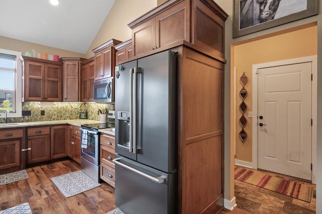 25455 145th St NW, Zimmerman, MN 55398 - kitchen with stainless steel appliances, vaulted ceiling, backsplash, a sink, and dark wood-style floors