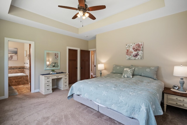 25455 145th St NW, Zimmerman, MN 55398 - bedroom with carpet, a tray ceiling, baseboards, ensuite bathroom, and ceiling fan