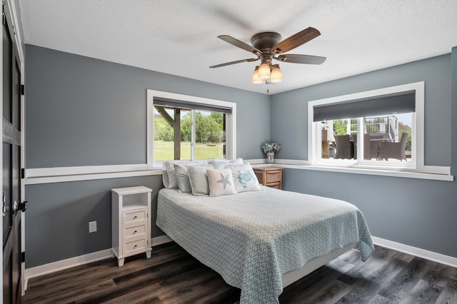 25455 145th St NW, Zimmerman, MN 55398 - bedroom featuring dark wood-style flooring, baseboards, a textured ceiling, and a ceiling fan