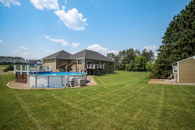 25455 145th St NW, Zimmerman, MN 55398 - view of green lawn with an outdoor pool, a wooden deck, and an outdoor structure