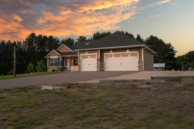 25455 145th St NW, Zimmerman, MN 55398 - view of front facade featuring stone siding, driveway, a garage, and a porch