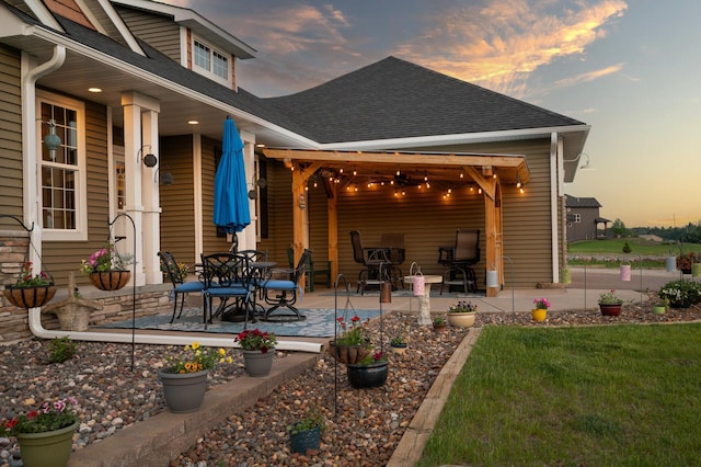 25455 145th St NW, Zimmerman, MN 55398 - patio terrace at dusk with a patio area and a lawn