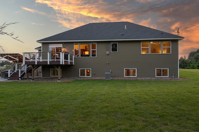 25455 145th St NW, Zimmerman, MN 55398 - back of property at dusk featuring a deck, cooling unit, stairs, a lawn, and a shingled roof