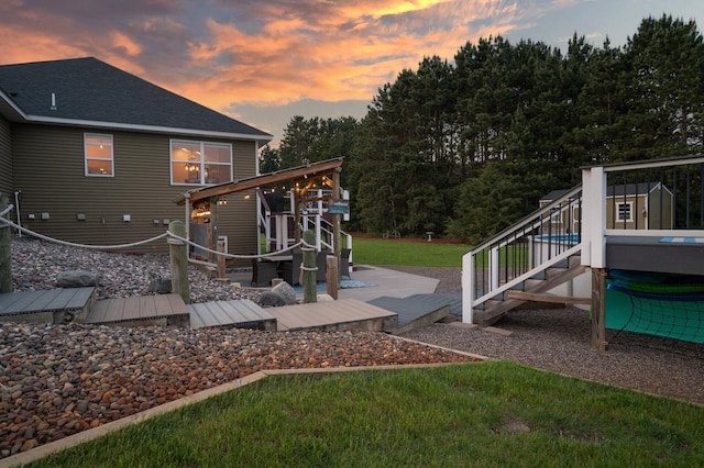 25455 145th St NW, Zimmerman, MN 55398 - yard at dusk featuring a wooden deck, a lawn, and stairs