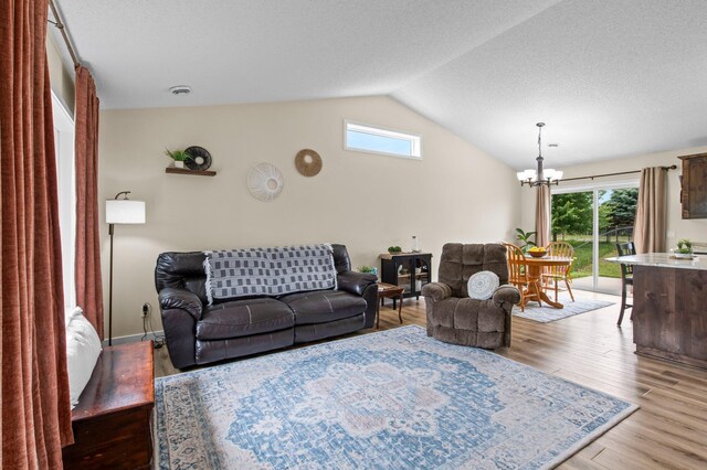 783 Park Brook Rd NW, Isanti, MN 55040 - living area with a chandelier, lofted ceiling, and light wood-style flooring