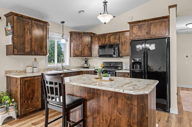 783 Park Brook Rd NW, Isanti, MN 55040 - kitchen with black appliances, a sink, light wood-type flooring, a center island, and decorative light fixtures