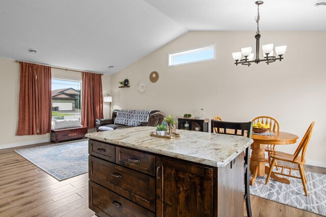 783 Park Brook Rd NW, Isanti, MN 55040 - kitchen featuring vaulted ceiling, light wood-style floors, a chandelier, and baseboards